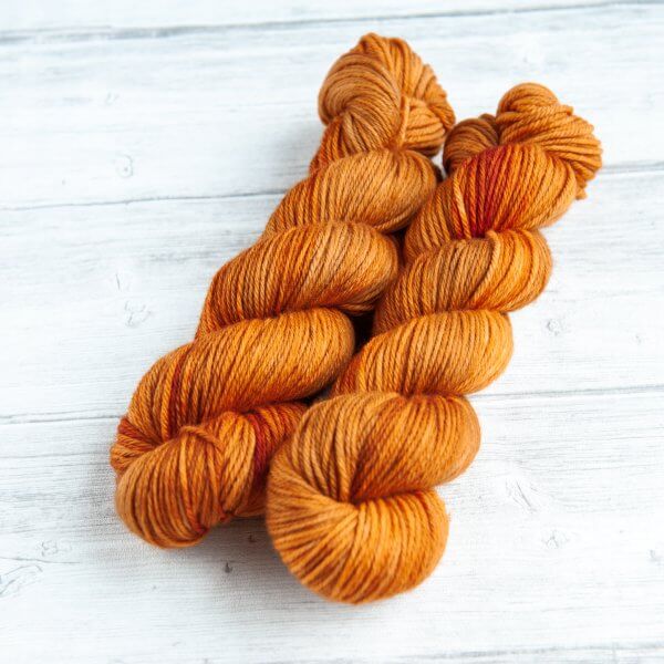 two skeins of yarn in the colorway 'Heilan Coo'