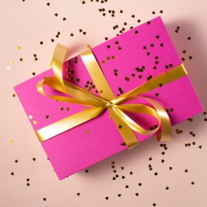 pink wrapped gift with golden bow