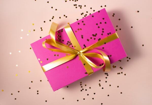 pink wrapped gift with golden bow