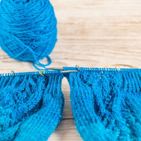 two knitted sleeves with metal stitch markers